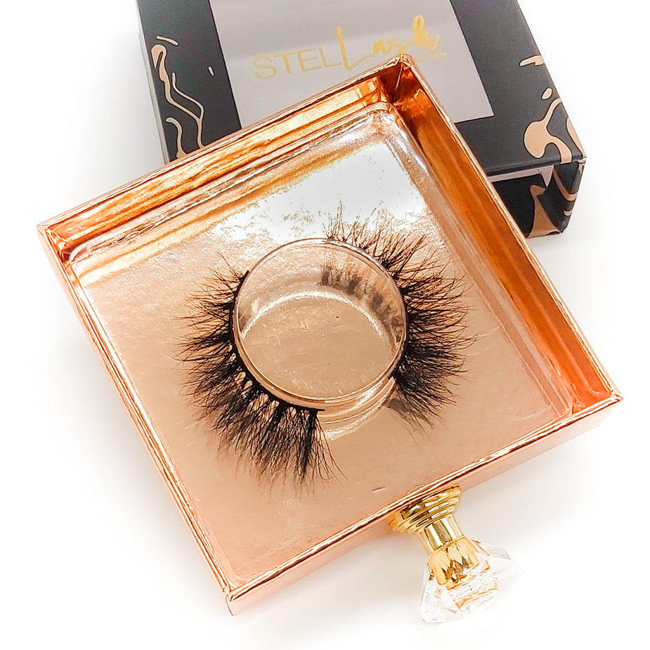 Opened gold lash box with Mink Lashes inside